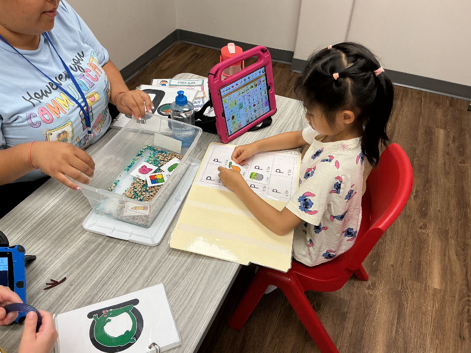 Child and teacher doing an activity at Merlin Day Academy