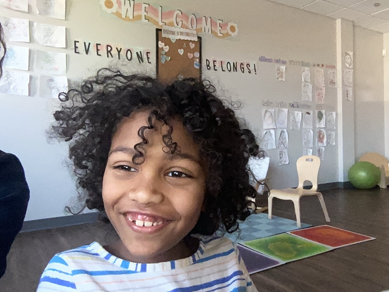 Happy child at Merlin Day Academy in class
